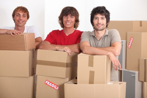 Professional movers in Sutton handling household belongings carefully