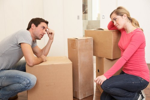 Local moving team organising packed boxes in Sutton