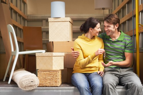 Professional movers handling household furniture in Sutton